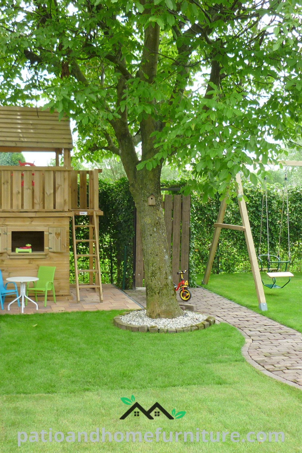 Wooden swing set in a lush green yard with a tree, showcasing a cozy play area design that promotes outdoor fun and family bonding, featured on wellnesswink.com.