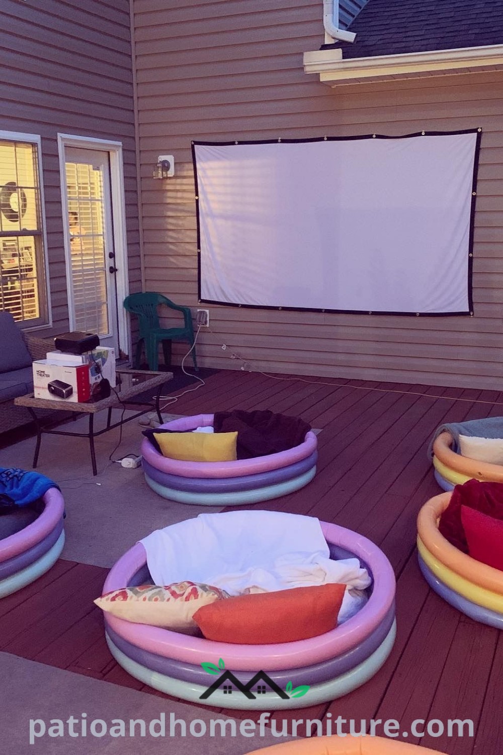 Outdoor movie setup featuring cozy bean bag chairs and loungers on a deck, creating a charming atmosphere for gatherings under the stars, with decorative lights and inviting snacks, showcased on wellnesswink.com.