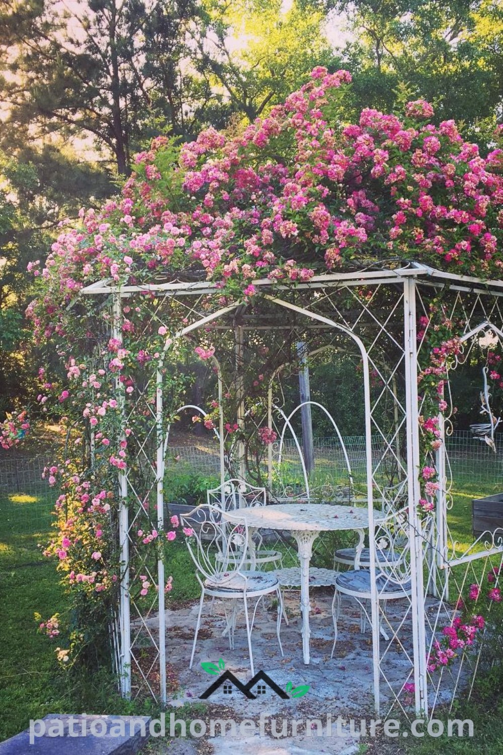 A cozy white gazebo enveloped in pink flowers, with lush greenery surrounding it, creating a charming romantic garden space that is ideal for gatherings and relaxation, offering unique decor ideas for your home at wellnesswink.com.